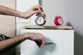 A man set up two alarm clocks Royalty Free Stock Photo