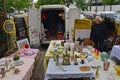 Man setting up antique stalls from van vehicle at Vanves flea market on early Saturday morning in Paris, France