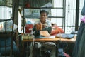 Man sewing in a small tailor shop
