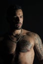 Man with sexy muscular torso. Bearded man with tattooed chest. Fit model with tattoo design on skin. Sportsman or