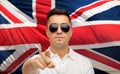 Man in shades pointing finger over brittish flag