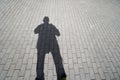 Man shadow on concrete pavement walkway Royalty Free Stock Photo