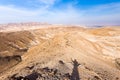 Man shadow hand up standing desert mountain ridge, Israel. Royalty Free Stock Photo