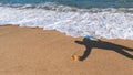 Man shadow on the hot sea sand Royalty Free Stock Photo