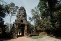 Man in the shadows at East entrance gate to Angkor Thom with smiling faces at top Royalty Free Stock Photo