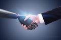 Man shaking robot hand, dark gray wall Royalty Free Stock Photo