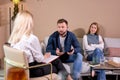 Man sharing problems with doctor, couple at psychologist therapy session in office Royalty Free Stock Photo