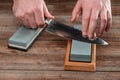 Man sharpening a Japanese knife with a whetstone