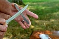 Man sharpening knife on carbide block stick