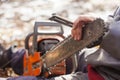 man sharpening motor chainsaw blade