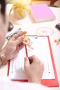 Man sharpening pencil with the help of sharpener. Picture of OMR sheet, clipboard, glasses, flower pot, circle scale and glasses Royalty Free Stock Photo