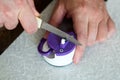 Man sharpens kitchen knife with a sharpener on the table Royalty Free Stock Photo