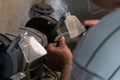 Man sharpens a knife on an electric grindstone