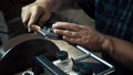 Man sharpens knives on a grinder. Close up hand Royalty Free Stock Photo