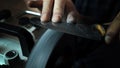 Man sharpens knives on a grinder. Close up hand Royalty Free Stock Photo