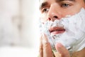 Man shaves his face Royalty Free Stock Photo