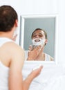 Man shaving in bathroom Royalty Free Stock Photo