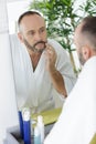man shaving in bathroom Royalty Free Stock Photo