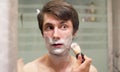Man shaving in the bathroom Royalty Free Stock Photo