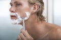 Man Shaving In Bathroom Royalty Free Stock Photo