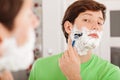 Man shaving in bathroom Royalty Free Stock Photo