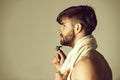 Man shaving in bathroom with safety razor and bathing towel Royalty Free Stock Photo