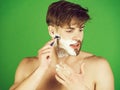 Man shaving in bathroom with safety razor and foam Royalty Free Stock Photo