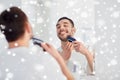 Man shaving beard with trimmer at bathroom Royalty Free Stock Photo