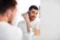 Man shaving beard with trimmer at bathroom Royalty Free Stock Photo