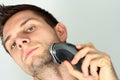 Man shaving face with electric razor Royalty Free Stock Photo