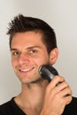 Man shaving face with electric razor Royalty Free Stock Photo