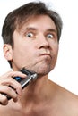 Man shaving face with electric razor Royalty Free Stock Photo