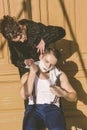 man with shaving foam on his face and towel around his neck siting on chair and posing while pretty women shave him Royalty Free Stock Photo