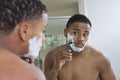Man Shaving In Front Of Bathroom Mirror Royalty Free Stock Photo