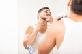 Man shaving his beard with an electric razor Royalty Free Stock Photo