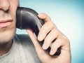 Man shaving his beard off with an electric shaver Royalty Free Stock Photo