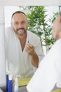 man shaving in mirror Royalty Free Stock Photo