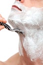 Man shaving with a razorblade Royalty Free Stock Photo