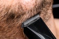 Man shaving or trimming his beard using a hair clipper Royalty Free Stock Photo