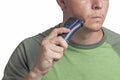Man is shaving using an electric razor. Man with an electric razor on a white background Royalty Free Stock Photo