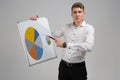 Young man holding a poster with a diagram isolated on a light background