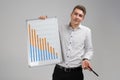 Young man holding a poster with statistics isolated on a light background