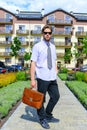 Man in shirt or businessman with serious face with building