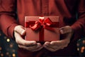 man in shirt holding gift cardboard box with red bow Royalty Free Stock Photo