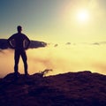 Man in shirt and jeans is standing on the peak of sandstone empire Royalty Free Stock Photo