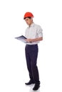 Man in a shirt orange construction helmet writes Royalty Free Stock Photo