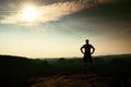 Man in shirt and pants on cliff of sandstone rock in national park Saxony Switzerland and watching over the misty and foggy morni Royalty Free Stock Photo