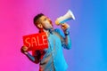 Man in shirt paying attention announcing big sale yelling at loudspeaker, black Friday shopping. Royalty Free Stock Photo