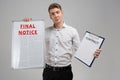 Young man holding final notice and contract isolated on light background Royalty Free Stock Photo