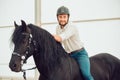 Man in a shirt riding on a brown horse Royalty Free Stock Photo